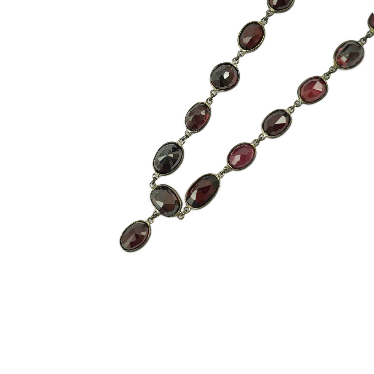 A Victorian silver and graduated oval cut two colour garnet set drop spectacle necklace, 74cm. Condition - poor to fair